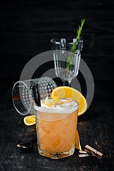 Whiskey Sauer. Alcoholic cocktail in a glass. On a wooden background.