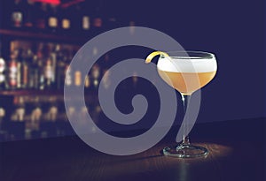 Whiskey Sour Cocktail - Bourbon with Lemon Juice, Sugar Syrup and Egg White in a special glass with copy space