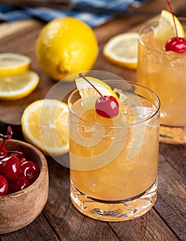Whiskey sour cocktail with cherry and lemon photo
