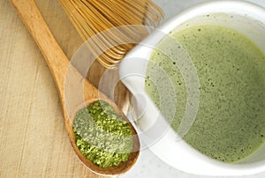 Whisking green Japanese Matcha powder in chawan with chasen