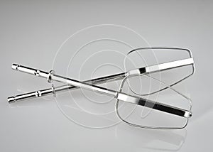 Whisks of electric mixer on white