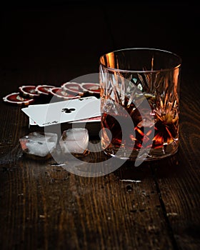 Whisky glass next to ice cubes