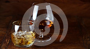 Whisky on the rocks and cognac in a snifter