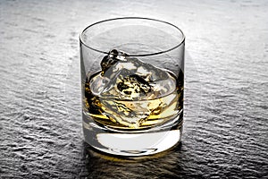 Whisky on the rocks in a glass tumbler photo