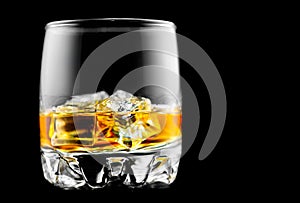 Whisky on the rocks. Glass of whiskey with ice isolated on black