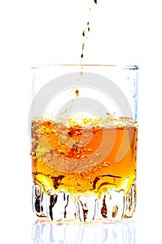 Whisky,rum or any other golden liquor being poured photo