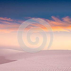 Whispy Clouds Full Of Color Dance Over White Sands