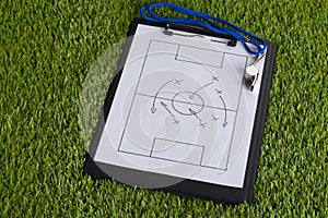Whistle and soccer tactic diagram on paper