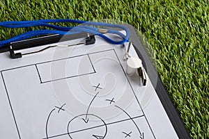 Whistle and soccer tactic diagram on paper