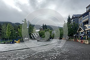 Whistler, BC, Canada - June 4, 2018. Olympic rings at Olympic Plaza on a rainy summer day.  Whistler was the Host Mountain Resort