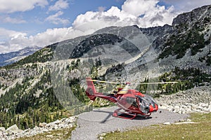 WHISTLER, CANADA - AUGUST 25, 2019: red helicopter on Blackcomb mountain for air lookup tour