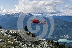 WHISTLER, CANADA - AUGUST 25, 2019: red helicopter on Blackcomb mountain for air lookup tour