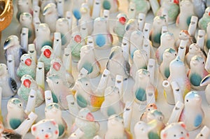 Whistles in shape of birds at ceramic pottery fair in Romania. Colored traditional ceramic whistles
