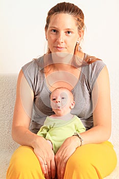 Whistling newborn baby boy on momÂ´s lap