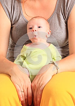 Whistling newborn baby boy on momÂ´s lap