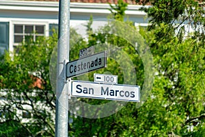 Whit and black road sign in the historic districts of san francisco california that says san marcos street and castenada