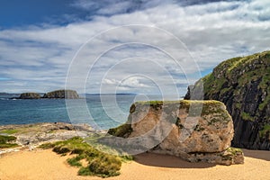 Whit rocks, cliffs and sandy beach at Ballintoy Harbour, Northern Ireland