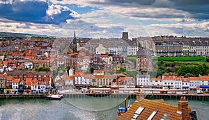 Whitby abbey is a seaside town and port at daytime in North Yorkshire, UK