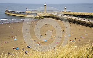 Whitby Beach and Harbour Piers in North Yorkshire