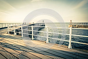 WHITBY, ENGLAND  Tourists visiting Whitby Pier and lighthouse. 12/05/2019