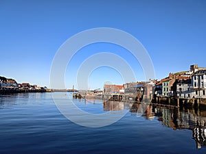 Whitby harbour blue sky over water North Yorkshire England UK