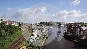 Whitby North Yorkshire England uk seaside town and tourist destination in summer with view of River Esk to Abbey