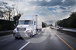 White 18 wheeler truck on highway at night