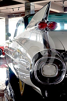 A white 1959 retro car, reflection in the mirrors, vertical photo