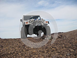 White 2002 Jeep Wrangler Driving on Hilly Dirt Road in Arizona
