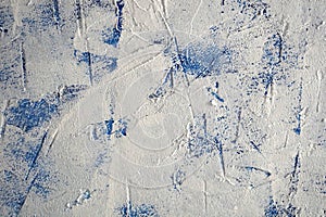 White abstract plaster texture on a blue background. Copy space. For design