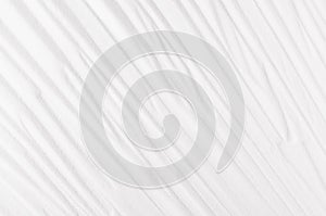 White abstract rippled smooth background with diagonal lines.