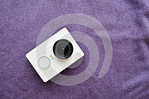 White action camera with a large black len