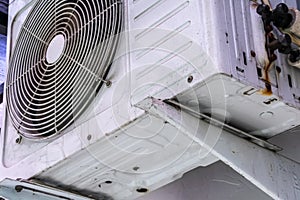 White air conditioner condensers hanging on the residential house wall