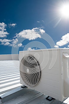 White air conditioning unit on a roof photo