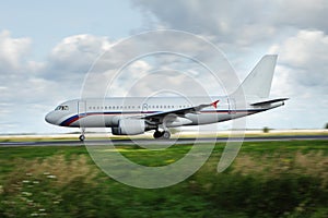 White airplane moves along Runway