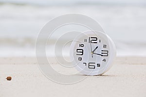 White Alarm Clock on Natural Beach