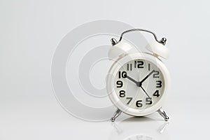 White alarm clock on seamless white background with reflection u