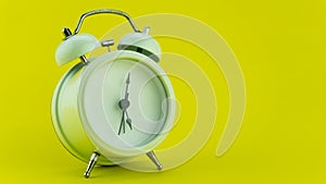 White alarm clock on yellow table background