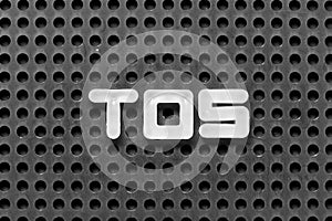 White letter in word TOS abbreviation of Terms of service on black pegboard background photo