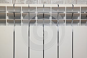 White aluminium hot water heating radiator. Heating convector in the bathroom.