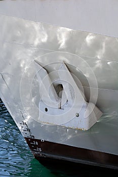 White anchor on a white ship. Shipping. Sea port. Freight and passenger transportation