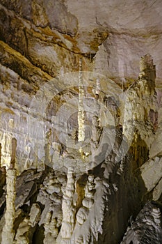 White ancient stalagmites closeup in the cages of Grotta di Frasassi, Genga, Marche, Italy.