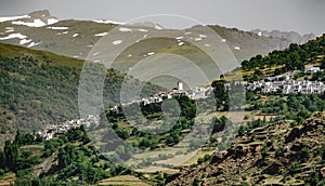 White Andalusian village of Capileira with Veleta peak photo