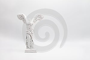 White angelic figure with wings on the white background