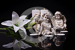 White angels with candles and white lily flower on a black background
