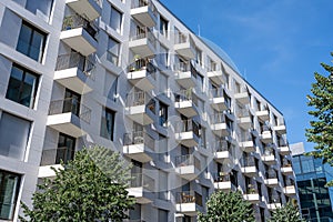 White apartment building with many small balconies