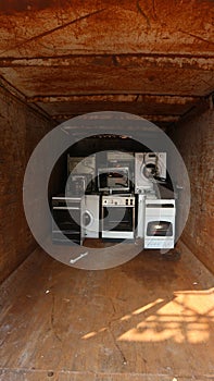 White appliances inside a container for the collection of electrical waste