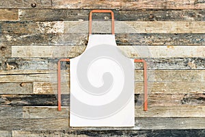 White apron on wooden background photo