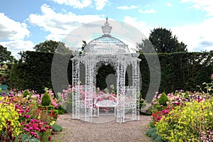 White arbour in a garden photo