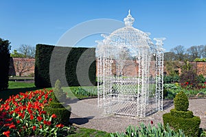White arbour in a large garden photo
